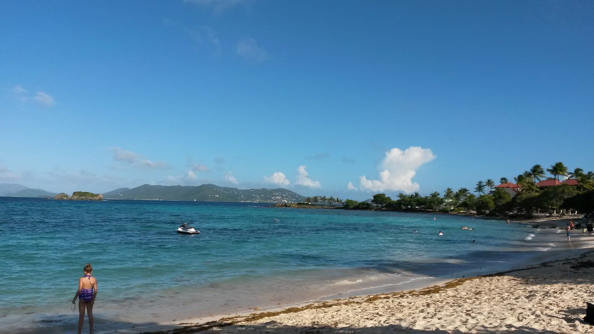 Swimmers in the clear water off Sapphire Beach on St. Thomas, with islands across the channel.